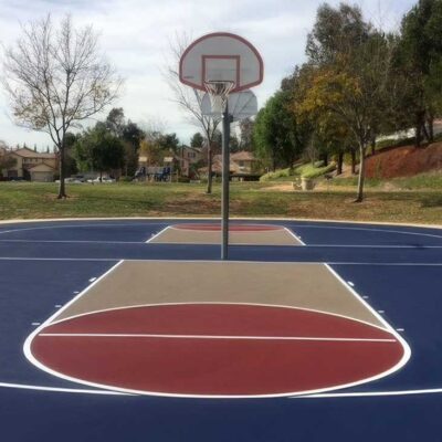 The Photo Shows Two Back-to-back Basketball Courts Restored And Resurfaced In Blue With Beige/red Keys And White Striping For Paseo Del Sol By Ferandell Tennis Courts.