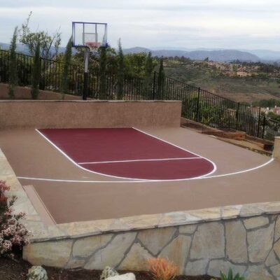 The Photos Shows A Private Residential Basketball Half-court In Red With Beige Surround And White Striping.