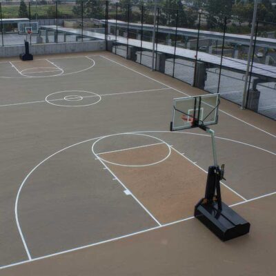 The Photo Shows A Beautiful Beige And Tan Basketball Court Built On The Top Of The Sony Building By Ferandell Tennis Courts.