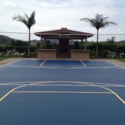 This Photo Shows A Multi-sports & Game Court With Yellow Lines For Basketball And White Lines For Volleyball.