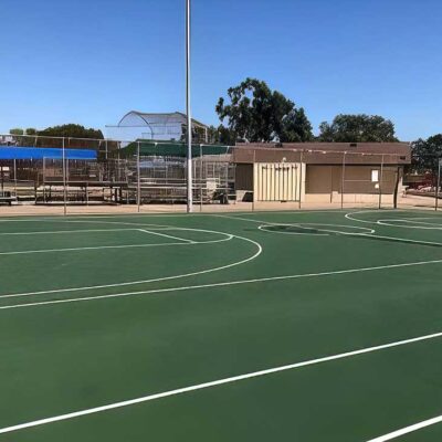 The Photos Shows A Repaired And Resurfaced Basketball Court In The Traditional Green With White Striping Completed By Ferandell Tennis Courts.