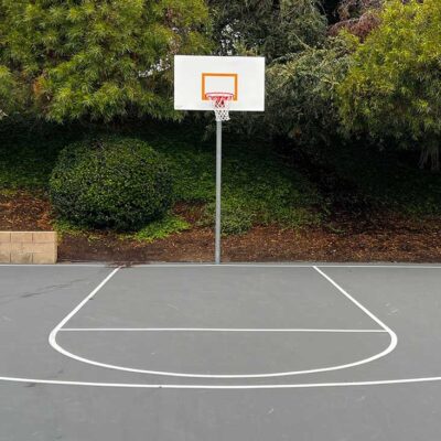 The Photos Shows What Appears To Be A Lonely, But Inviting Little Basketball Court In Gray.