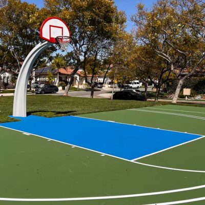 The Photos Shows A Beautiful Basketball Court With A Blue And Green Combination Of Colors And White Striping.