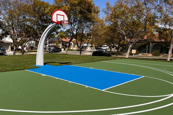 The Photos Shows A Beautiful Basketball Court With A Blue And Green Combination Of Colors And White Striping.