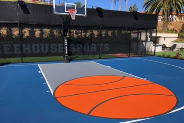 The Photo Shows An Orange Basketball Painted In The Key Area Of A Blue Basketball Court With White Striping.