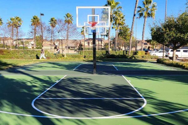 This Photo Shows Two Basketball Half-courts In A Dark Green And Light Green Combination Built By Ferandell Tennis Courts For Roripaugh Ranch In Temecula California.