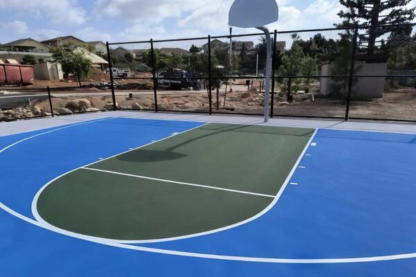 The Photo Shows A Pretty Color Combination On A Residential Basketball Court Using Medium Green And Light Blue With A Gray Surround.