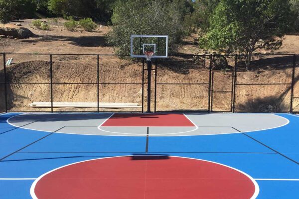 The Photo Shows A Bright Blue Basketball Full Court With Red And Grey Colored Areas With White Striping And Black Pickleball Striping.
