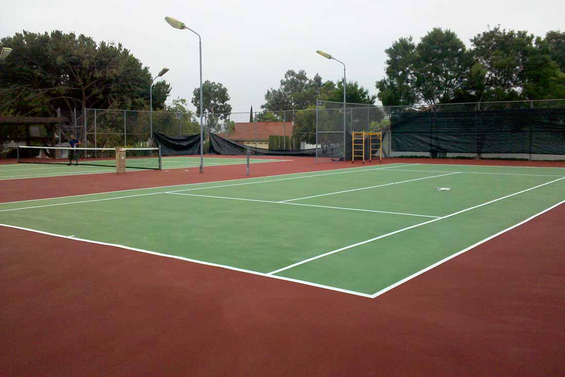 photo shows a gorgeous tennis court after cracks were repaired and the court was resurfaced.