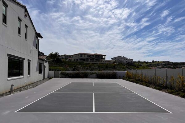 The Photo Shows A Nice Residence With A New Pickleball Court In Gray With A Dove Gray Surround Built By Ferandell Tennis Courts.