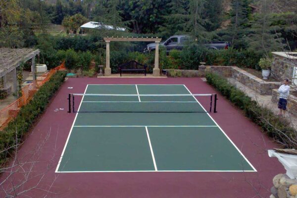 The Photo Shows A Beautiful Forest Green Pickleball Court With A Maroon Surround Built By Ferandell Tennis Courts