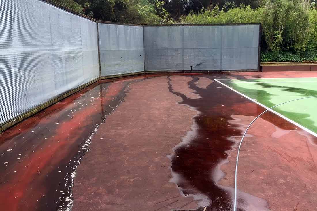 photo shows a sports court desparately in need of power washing.