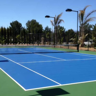 Very Popular Color Combination Of Blue Tennis Court With A Green Surround Built By Ferandell Tennis Courts.