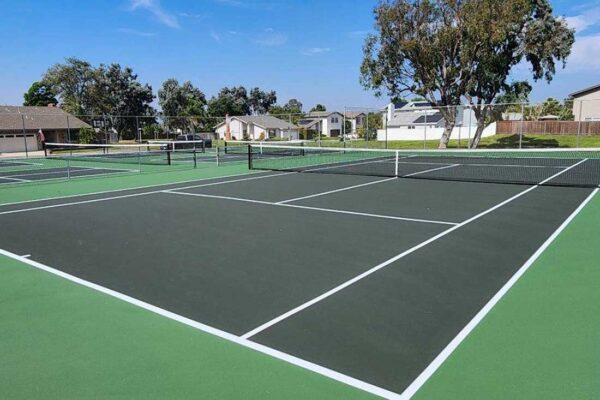 Tennis Court And Several Pickleball Courts Built In Dark Green With Light Green Surrounds By Ferandell Tennis Courts In San Marcos, California