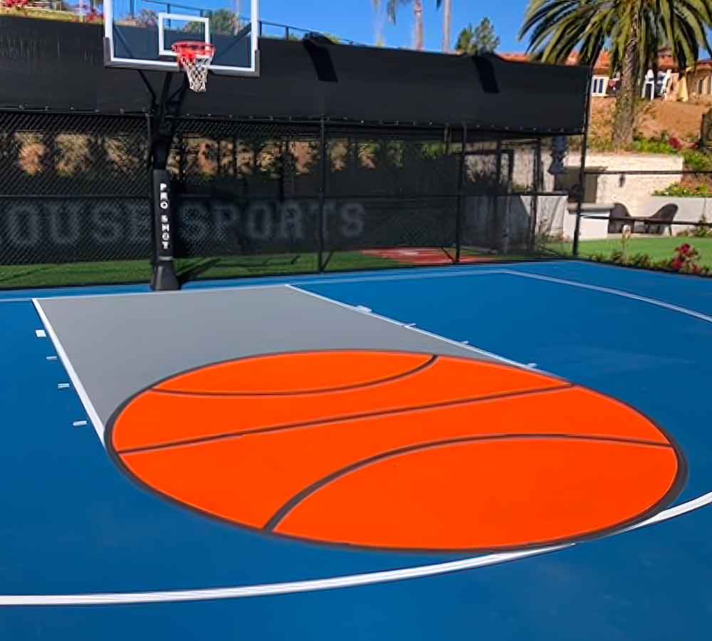 photo shows a basketball court with a visual of a basketball in the free throw circle.