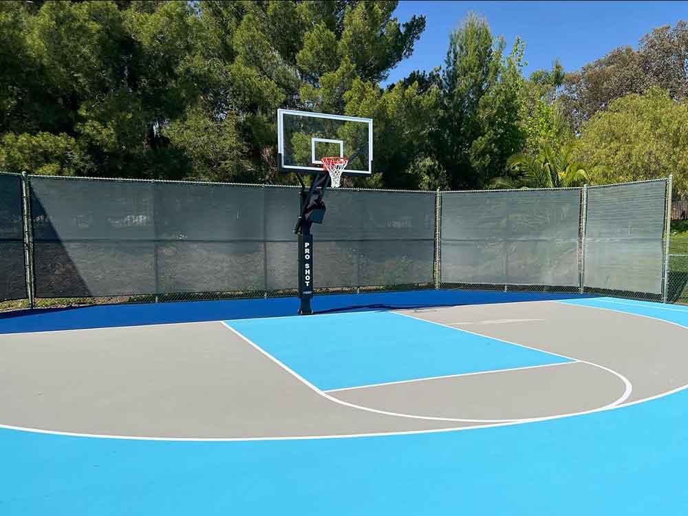 the photo shows a round court with 3 basketball lanes going out from the center with three different hoops at the ends of the lanes.