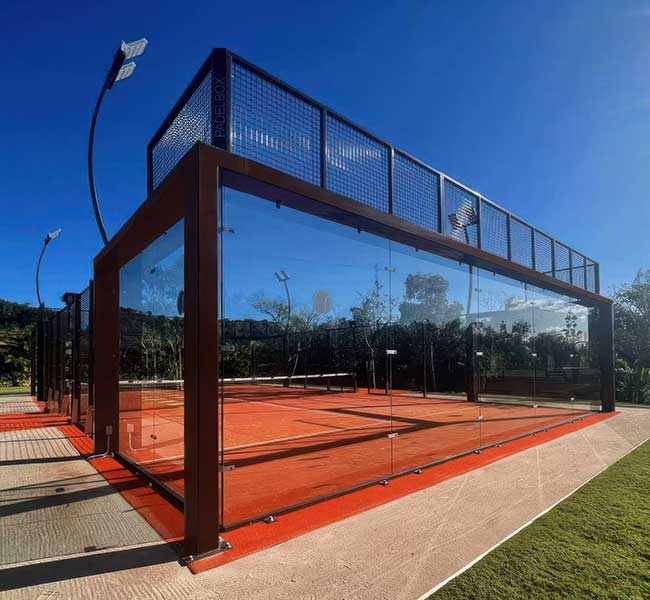 photo shows a beautiful padel tennis court with a black and glass enclosure by ferandell tennis courts