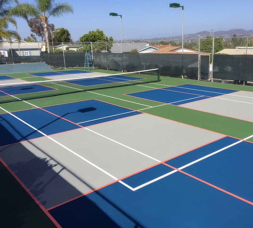 the photo shows a multiple-sport court of tennis overlaid with four pickleball courts.