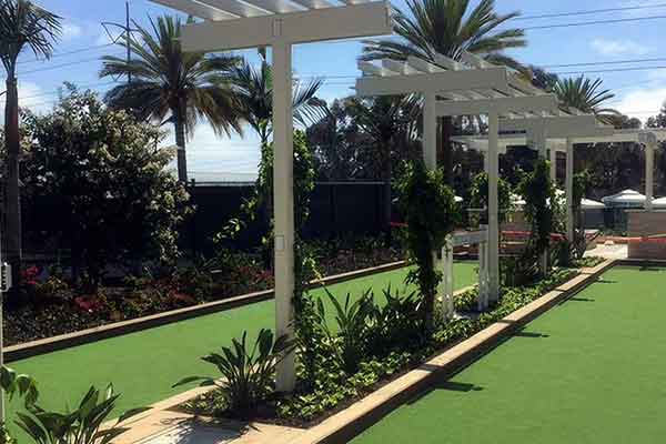 photo shows a gorgeous bocce ball courts in bright green built for the Bay Club-1