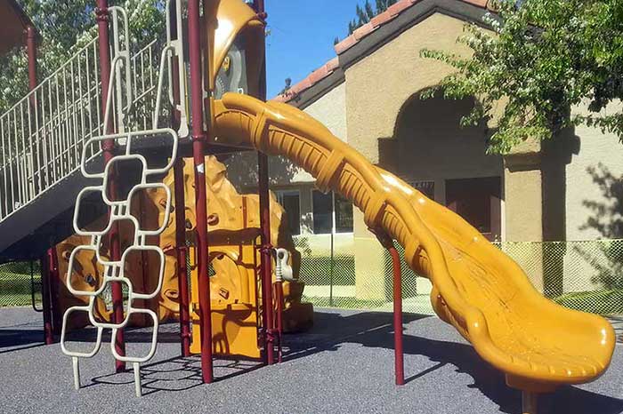 photo shows a resurfaced children's playground by ferandell tennis courts.-1